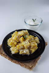 Ongol ongol ubi. Indonesia traditional cake that made from sweet potatoes. It's steamed and wraped with grated coconut after cooked