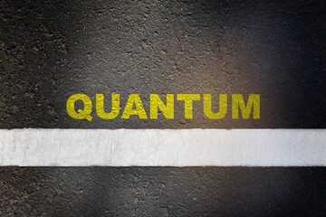 Quantum word written on asphalt road surface with white starting lines and sport shoe. Innovation...
