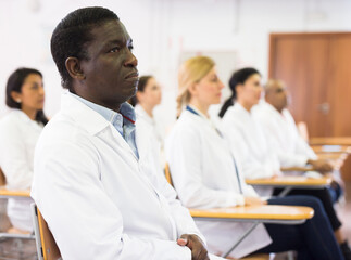 Fototapeta premium Confident african american doctor attending lectures within refresher course. Professional development concept