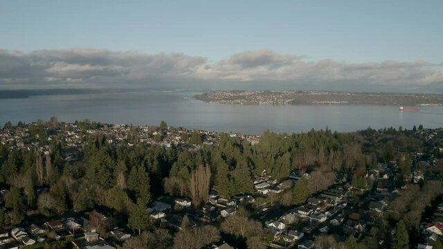 Scenery Of Tranquil City Village With Blue Water In Background Under Cloudy Sky In Proctor City, Tacoma, Washington. - Aerial Drone Shot
