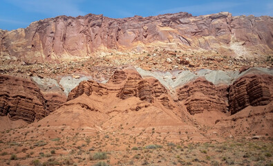 Sublime monoliths and towering sandstone cliffs on a hot partly cloudy summer day at Capitol Reef National Park in Southern Utah.