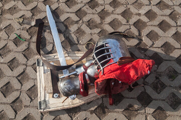 Medieval infantry helmet, shield, gauntlet and sword at the historical festival