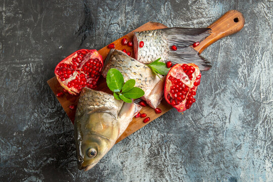 Top View Sliced Fresh Fish With Pomegranates On Dark Background Ocean Dish Seafood