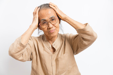 Old asian woman touch her head feel headache standing on white background.