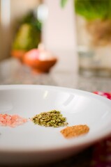 Dried oregano in a white dish. Extreme close up.