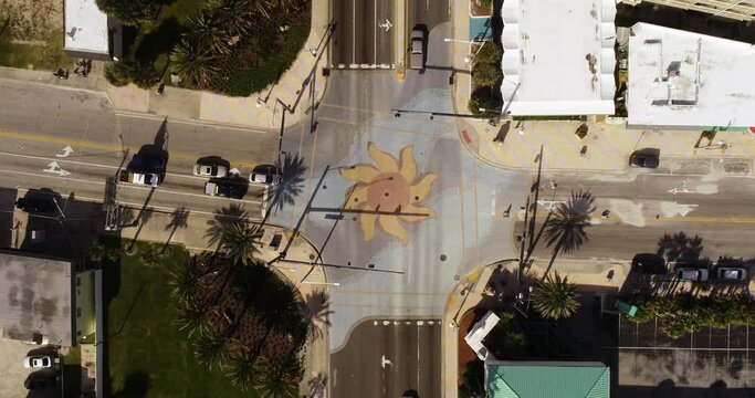 "Daytona Beach, FL USA - 12-10-2020: Top-down drone video footage of the iconic sun murals at the International Speedway intersection in Daytona Beach."