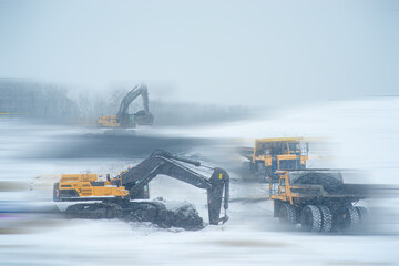 Big yellow dump truck and excavator in coal mine 