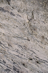 Close-up of textured rock, with small cracks, as a nature background
