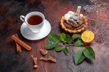 top view cup of tea with delicious little cake on dark background cookies dessert biscuit