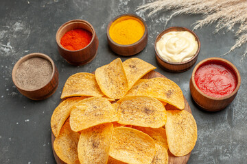 Set potato chips containing different spices mayonnaise and ketchup on gray background stock image