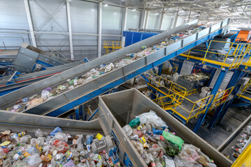 Waste sorting plant conveyors filled with various household waste.
