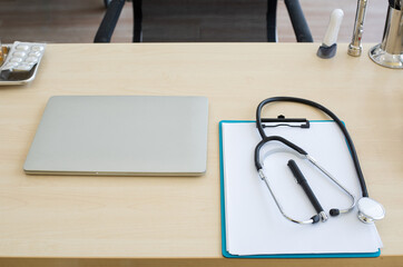 Stethoscope and laptop and other medical object on table of doctor.