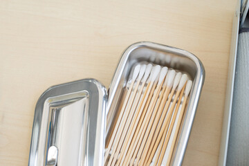 Cotton bud in stainless container on table in doctor room container for surgical.