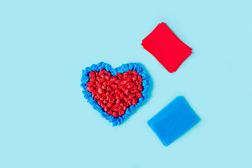 Concept of DIY and kid's creativity. Step by step instruction: make  heart. Step 5 finished craft heart from red and blue crumpled colored paper. Valentine's Day craft. Fine motor skills