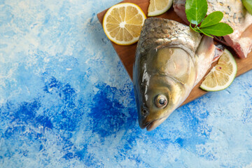 top view sliced fresh fish with lemon slices on light blue background food ocean dish seafood