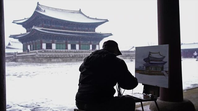 Person Photographing Traditional Korean Palace in Winter.