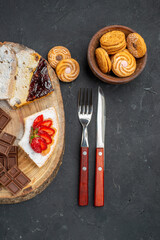 top view cake slices with choco bars and cookies on dark background fruit sweet biscuit