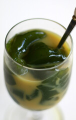Green grass jelly ice or es cincau on white background. Indonesian traditional drink. 