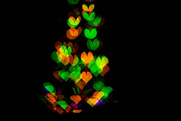 bokeh of light in the form of bright colored hearts