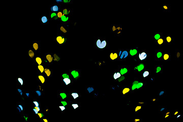 Fototapeta na wymiar bokeh of light in the form of bright colored hearts
