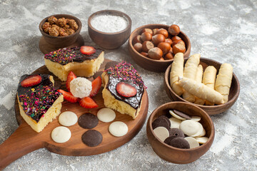 front view delicious cake slices with cookies and nuts on white background dessert cake sweet