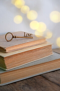 love Key and old books on wooden table. atmosphere inspiration romantic image. Valentine's day concept.