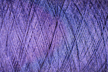 Background of a close up of purple   thread for sewing fabric: seamless pattern of twisted thread in a trendy color, soft focus, selective focus, space for text