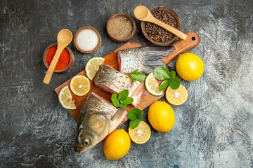 top view sliced fresh fish with lemon and seasonings on light background ocean raw seafood