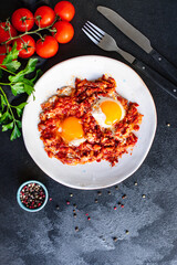 breakfast eggs fried tomato, onion and vegetables shakshuka omelette natural snack on the table healthy meal snack top view copy space for text food background rustic 