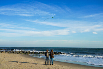 Two young women flying kite at Atlantic beach