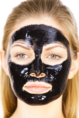 Woman with black peel off mask on face