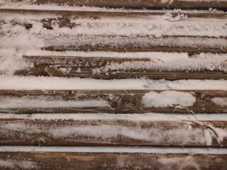 Snow-covered bench on the street of Moscow at night.