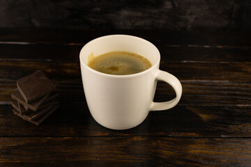 A Cup of coffee with foam and dark chocolate