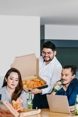 latin people coworkers eating pizza and drinking beer in office at Mexico city Happy Hour