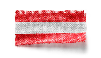 Austria flag on a piece of cloth on a white background
