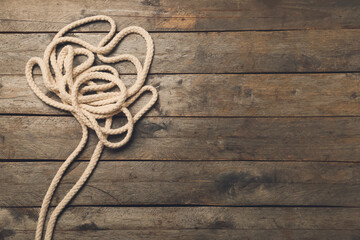 Obraz premium Long rope on wooden background