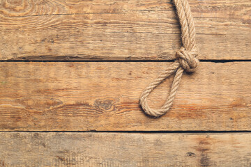 Obraz premium Rope with knot on wooden background