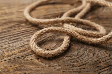 Fototapeta na wymiar Long rope on wooden background