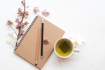 notebook planner for business work with healthy drinks hot green tea arrangement flat lay style on...