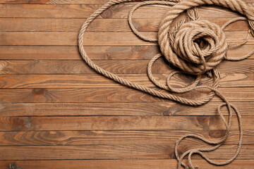 Long ropes on wooden background © Pixel-Shot