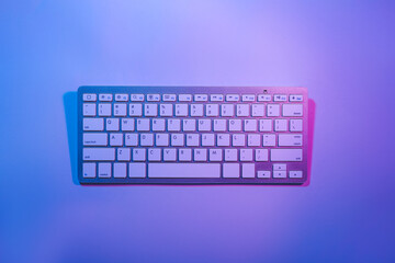Computer keyboard on color background
