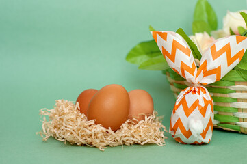 Easter bunny made of paper and an egg on a green background. Easter background.