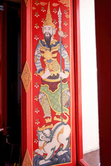 Chinese painting art on temple window The gods and lions patterns are brightly colored.