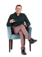 Male psychologist sitting in armchair against white background