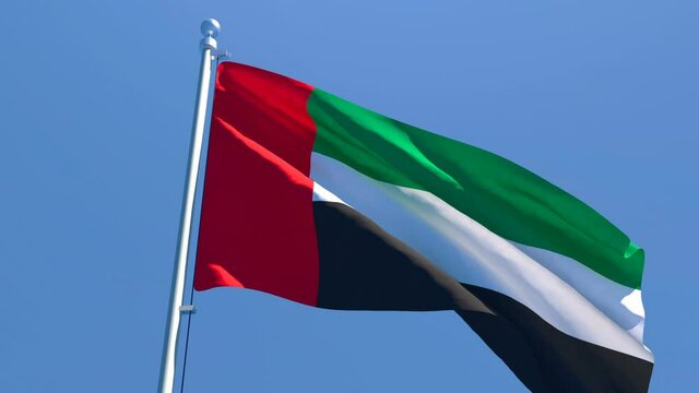 The national flag of UAE flutters in the wind