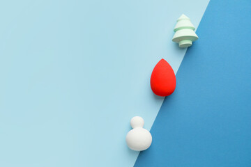 Beautiful makeup sponges on color background