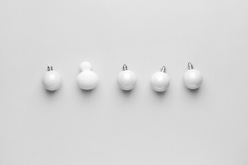Christmas balls and makeup sponge on white background