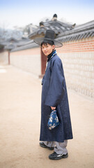 Asian male teenager Wear the South Korean national costume Visit The Gyeongbokgung Palace, Seoul South Korea.