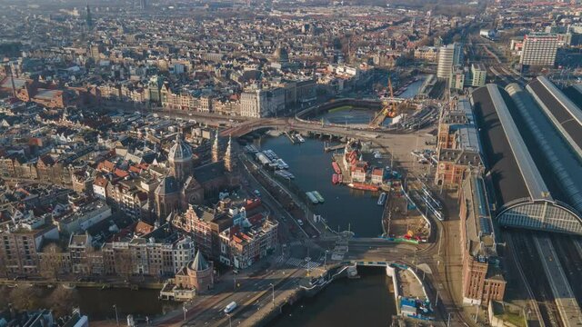 Amsterdam Central Aerial view timelapse hyperlapse, the city center in Amsterdam and the Ij river, The Netherlands ferries and public transport fly over drone shot.