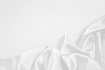 White silk satin fabric background. Copy space for text or product. Wavy soft folds. Beautiful...